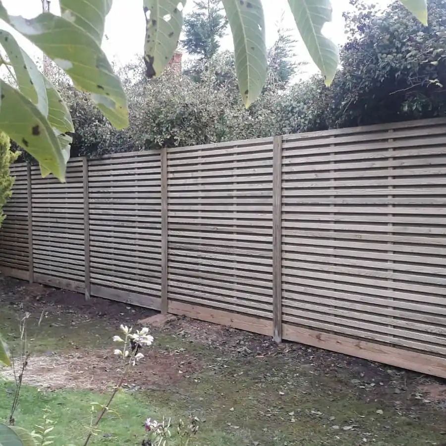 Contemporary slatted garden fencing installed by Harper Fencing